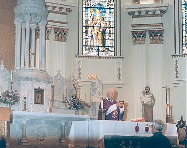 Father Edward J. Carter celebrating Mass at Our Lady of the Holy Spirit Center